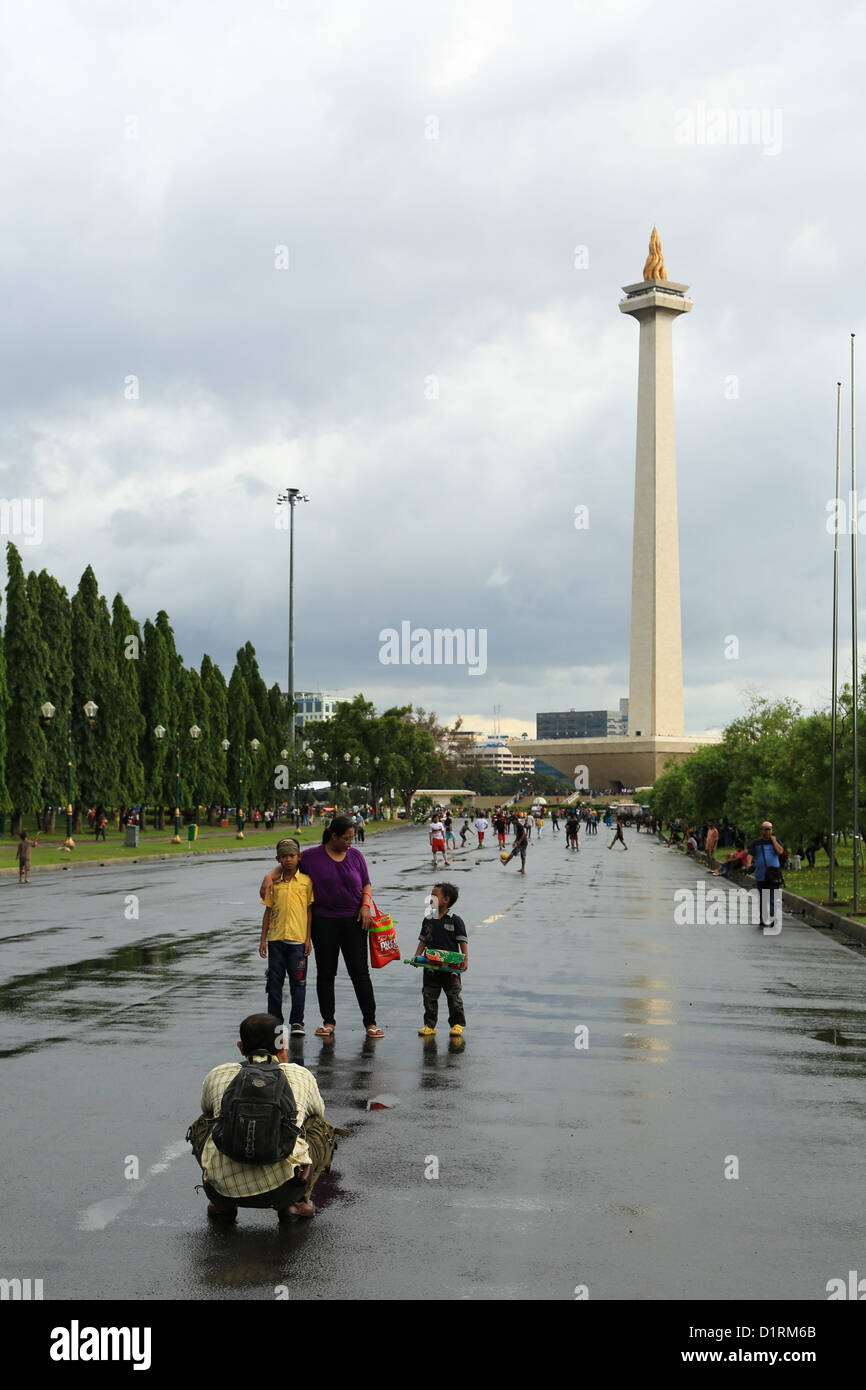 Asians tourists taking a family portrait in front of MONAS (national monument) in central Jakarta, Indonesia Stock Photo