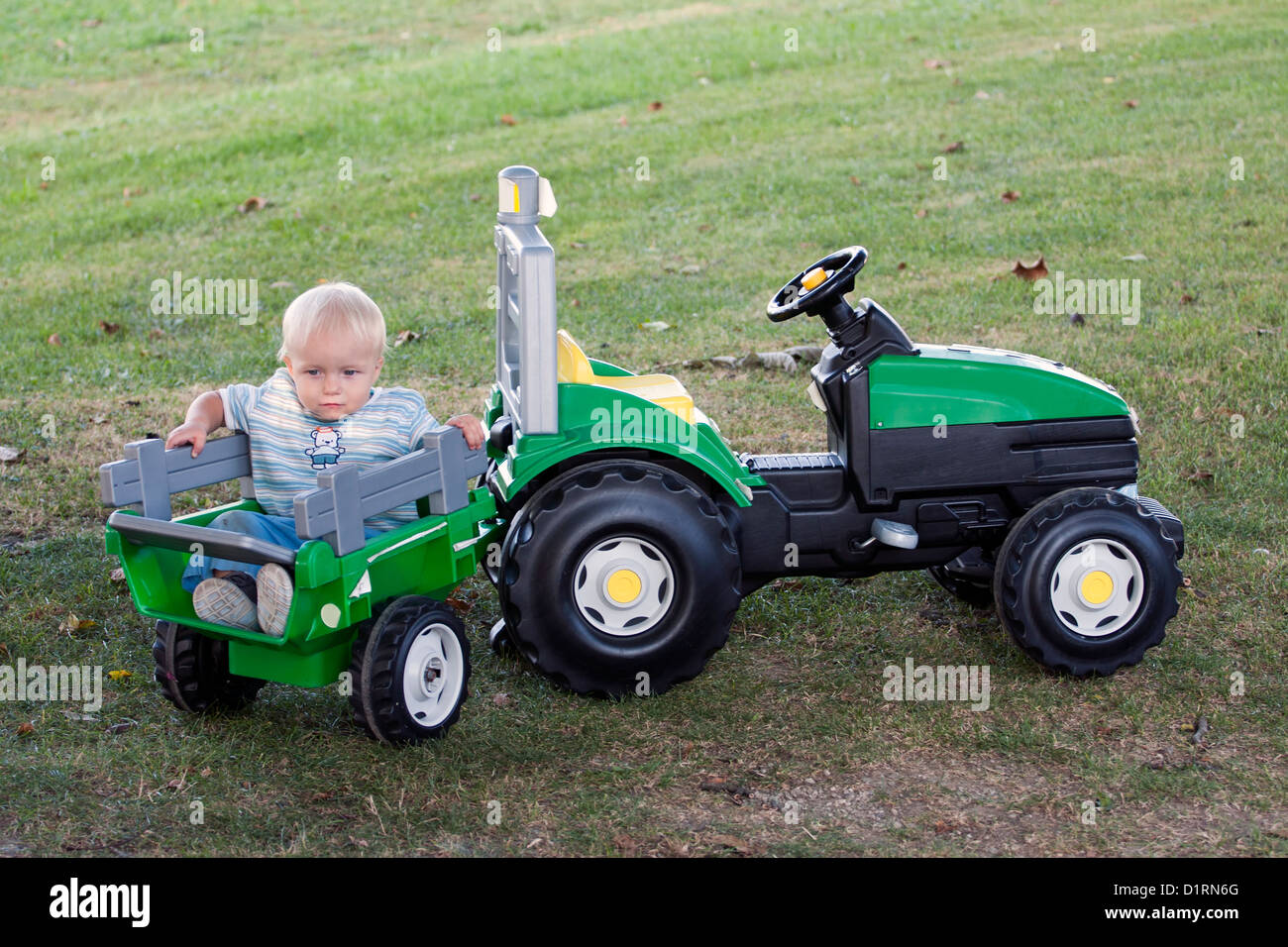 sit on toy tractor and trailer