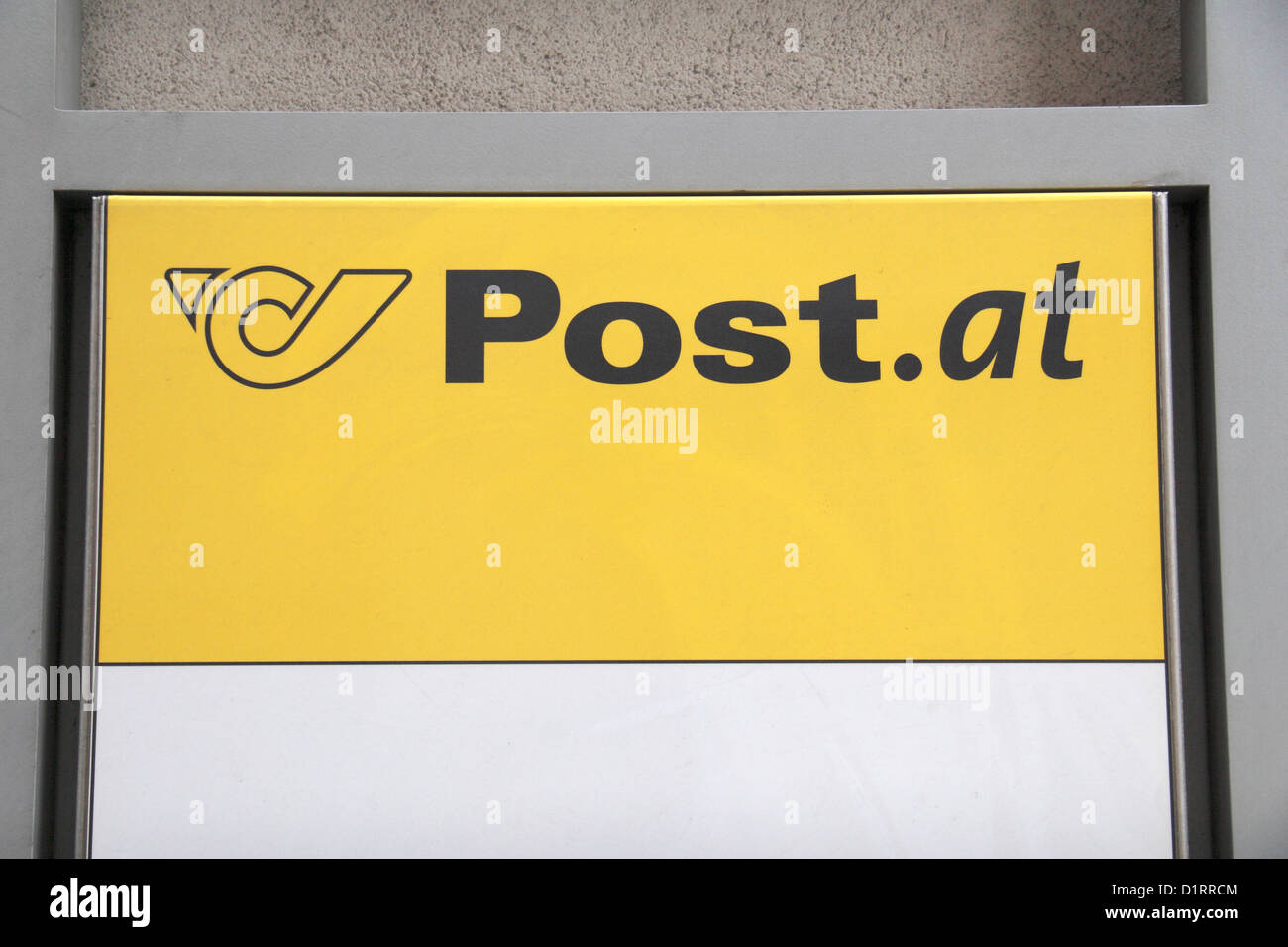 The bright yellow Österreichische Post (Austrian Post Office) logo outside a branch in Vienna, Austria. Stock Photo