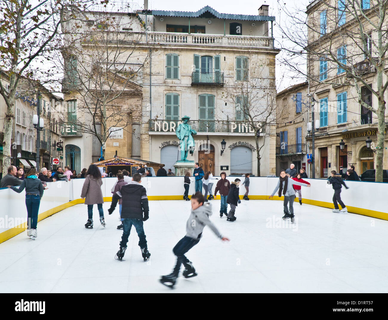 Ice skating at the Arles market ice rink in Southern France Stock Photo -  Alamy