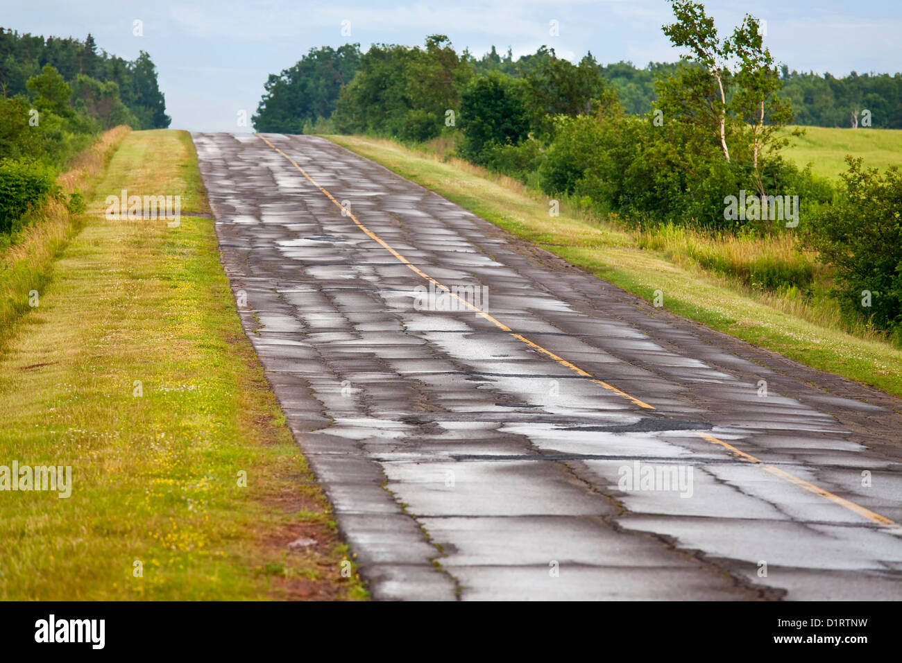 A paved asphalt road broken up from freezing and thawing. Cold patch is