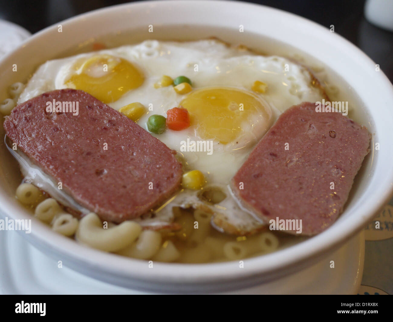 fried eggs spam meat macaroni in soup Stock Photo Alamy