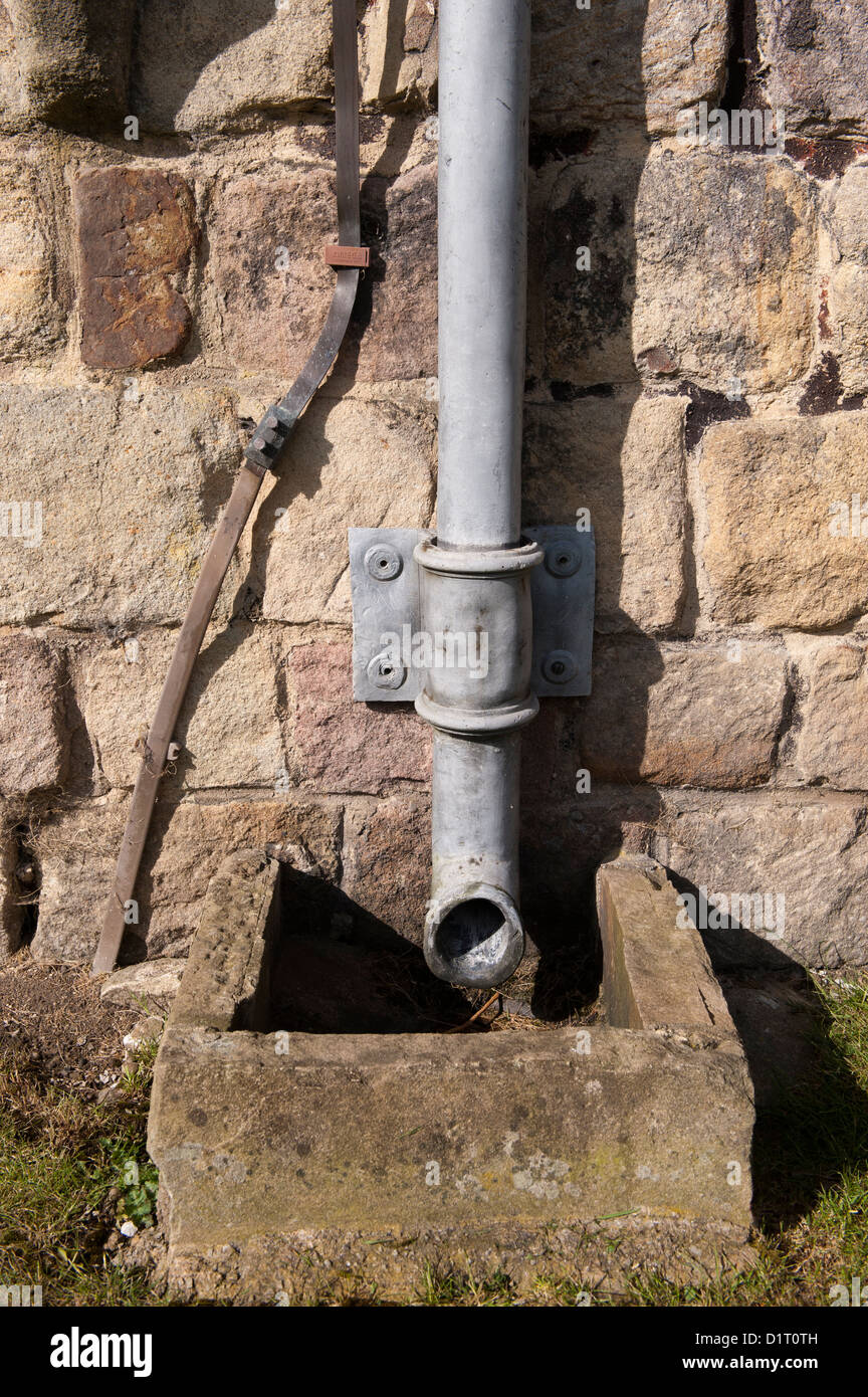 Lead downspout on side of Bolton Abbey, an historic building in the Yorkshire Dales Stock Photo