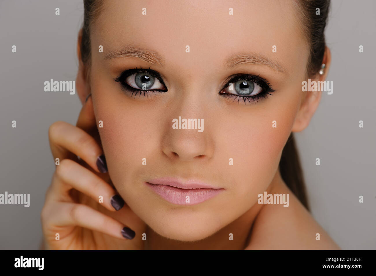 Pretty Girl, beauty portrait on a grey background. Stock Photo
