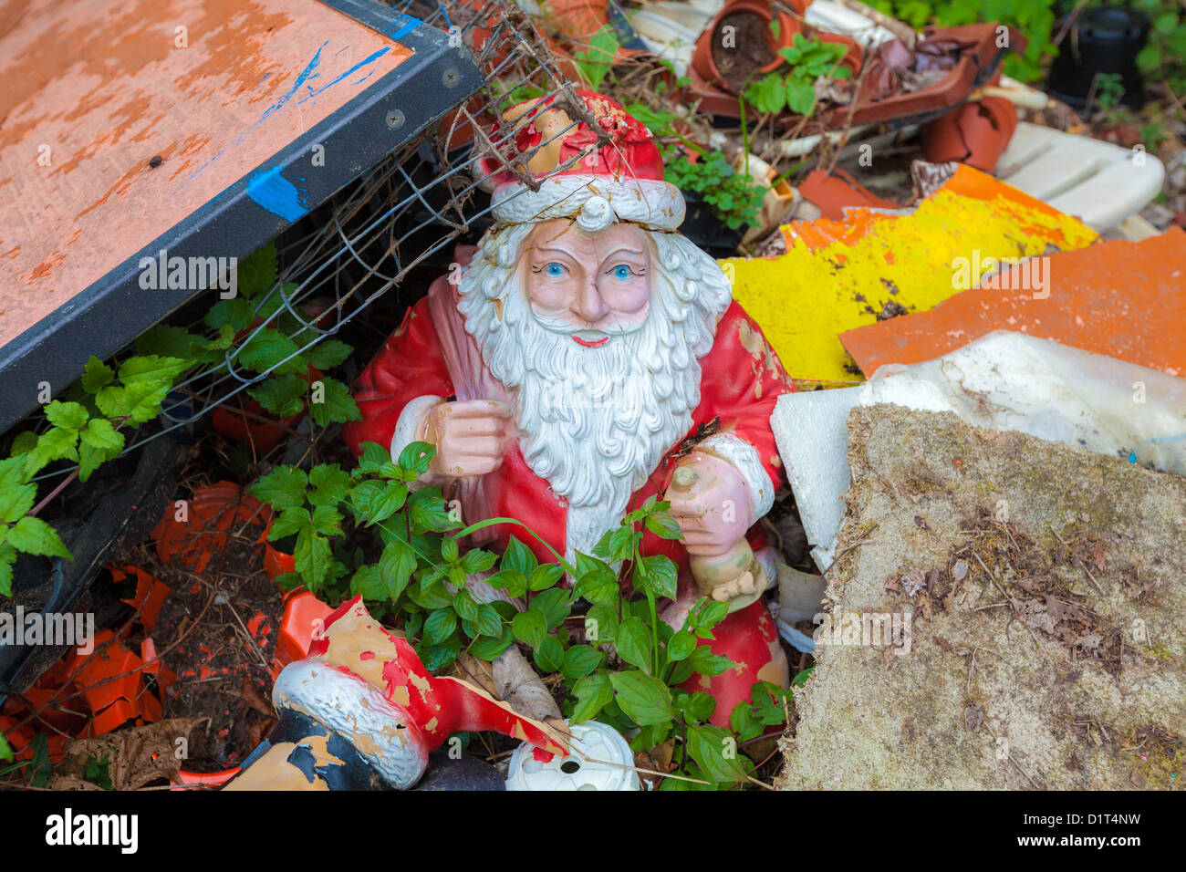 Broken Santa Claus Figure in the garbage Stock Photo