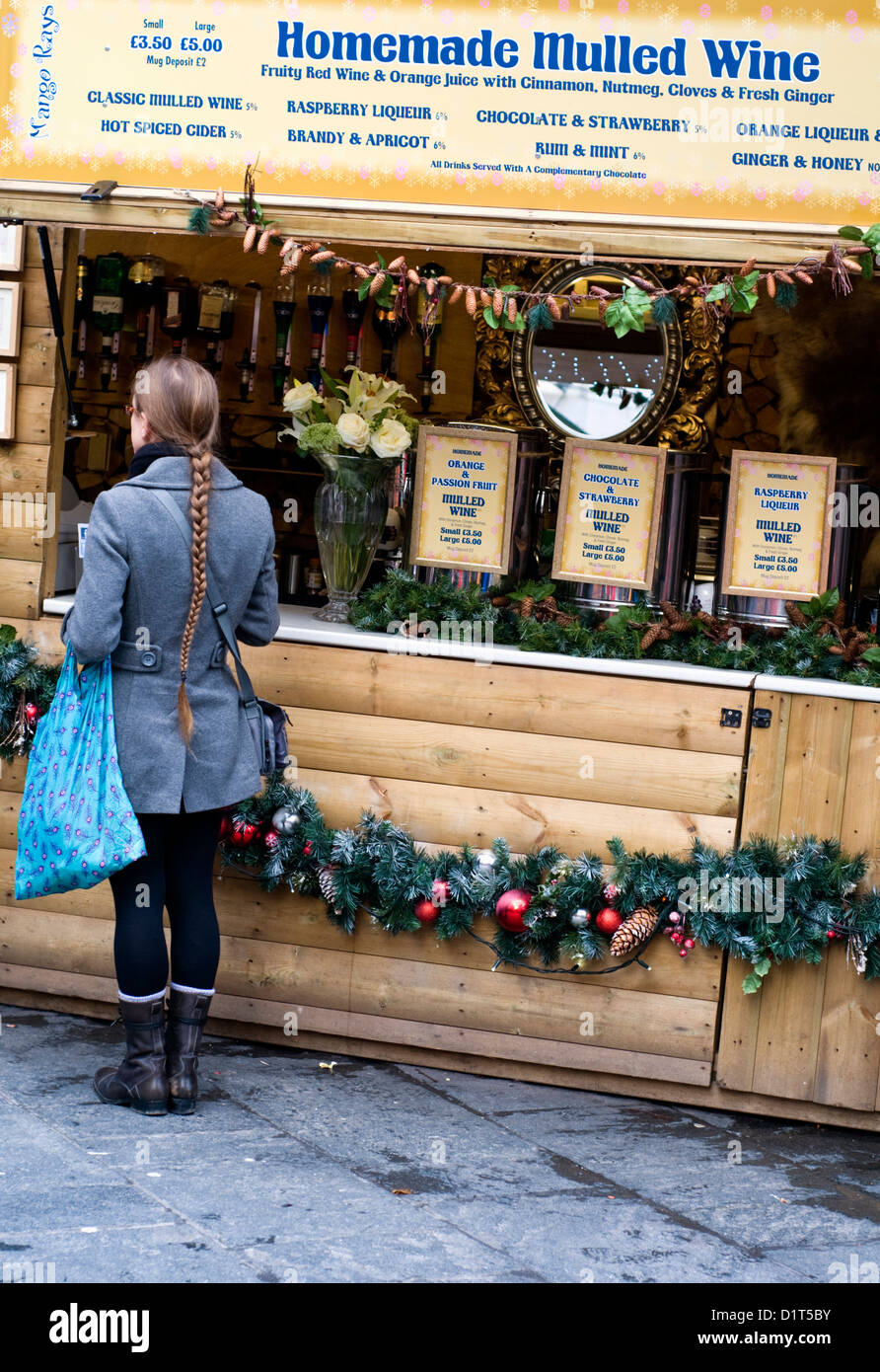 Visitor at a mulled wine stall, Manchester Christmas market, England, UK Stock Photo
