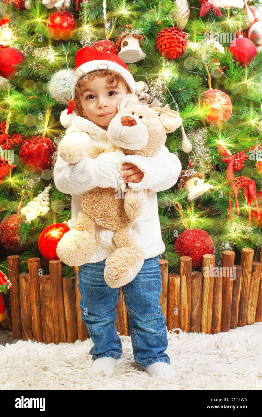 Picture of happy small boy holding teddy bear in hands on beautiful ...