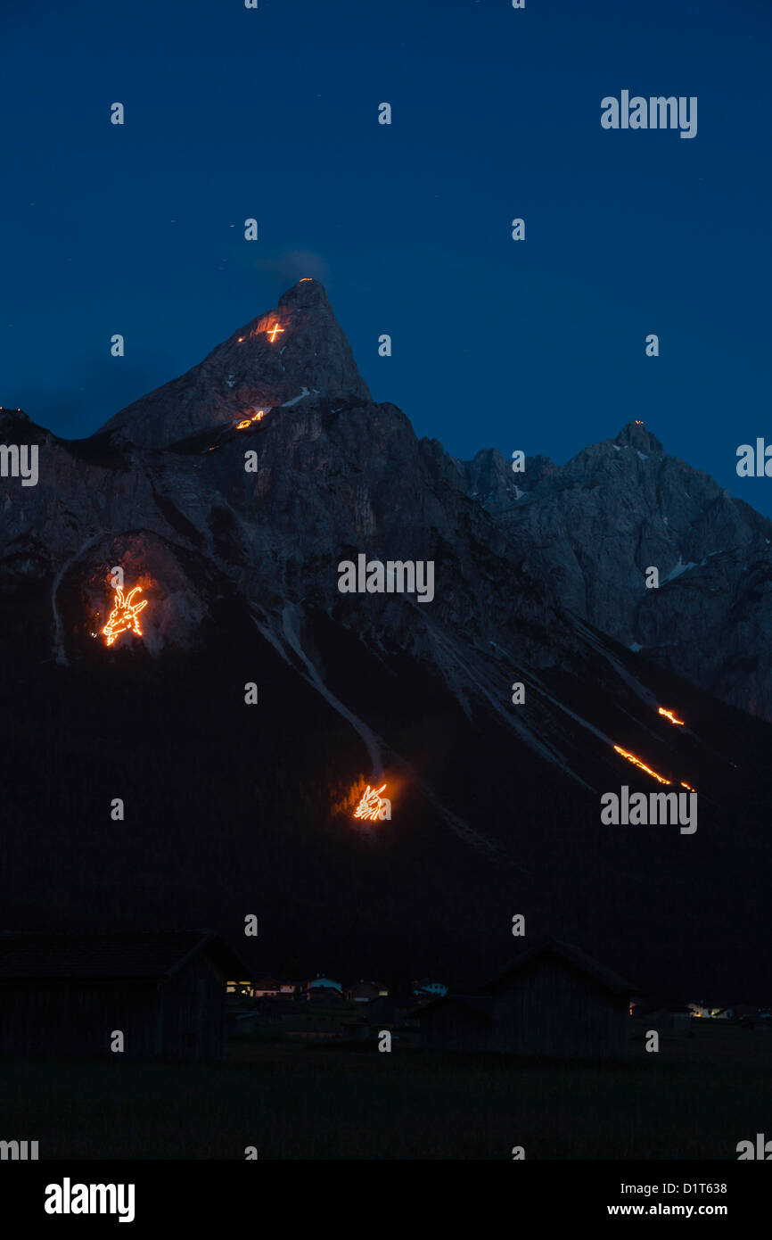 Mountain bonfires in Ehrwald basin during solstice in Tyrol, Austria. Stock Photo