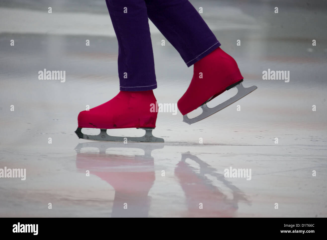 woman Ice skater's legs and feet on the ice Stock Photo