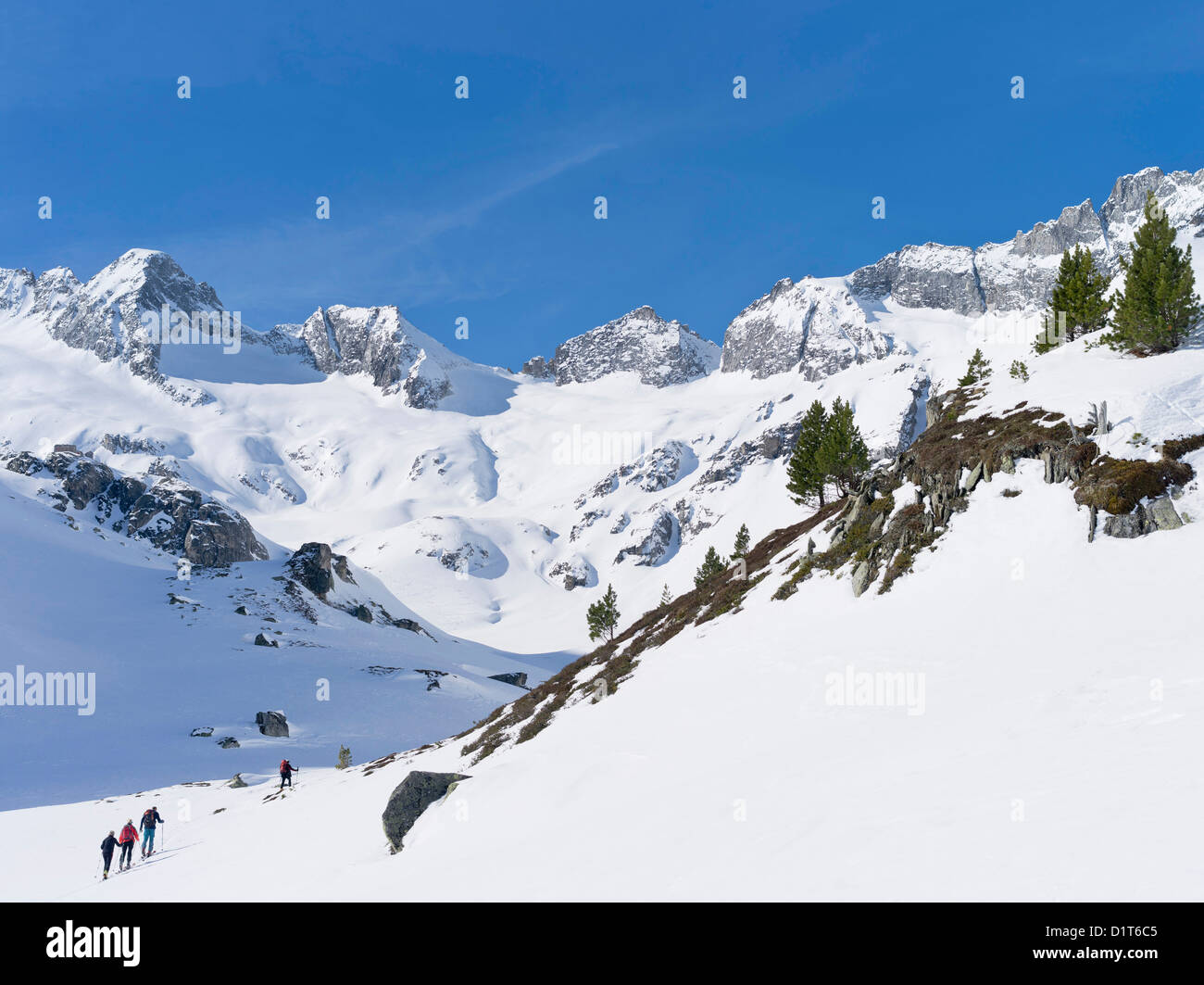 Valley Rainbachtal  in the National Park Hohe Tauern with Richterhuette mountain hut as a group of back country skiers ascends. Stock Photo