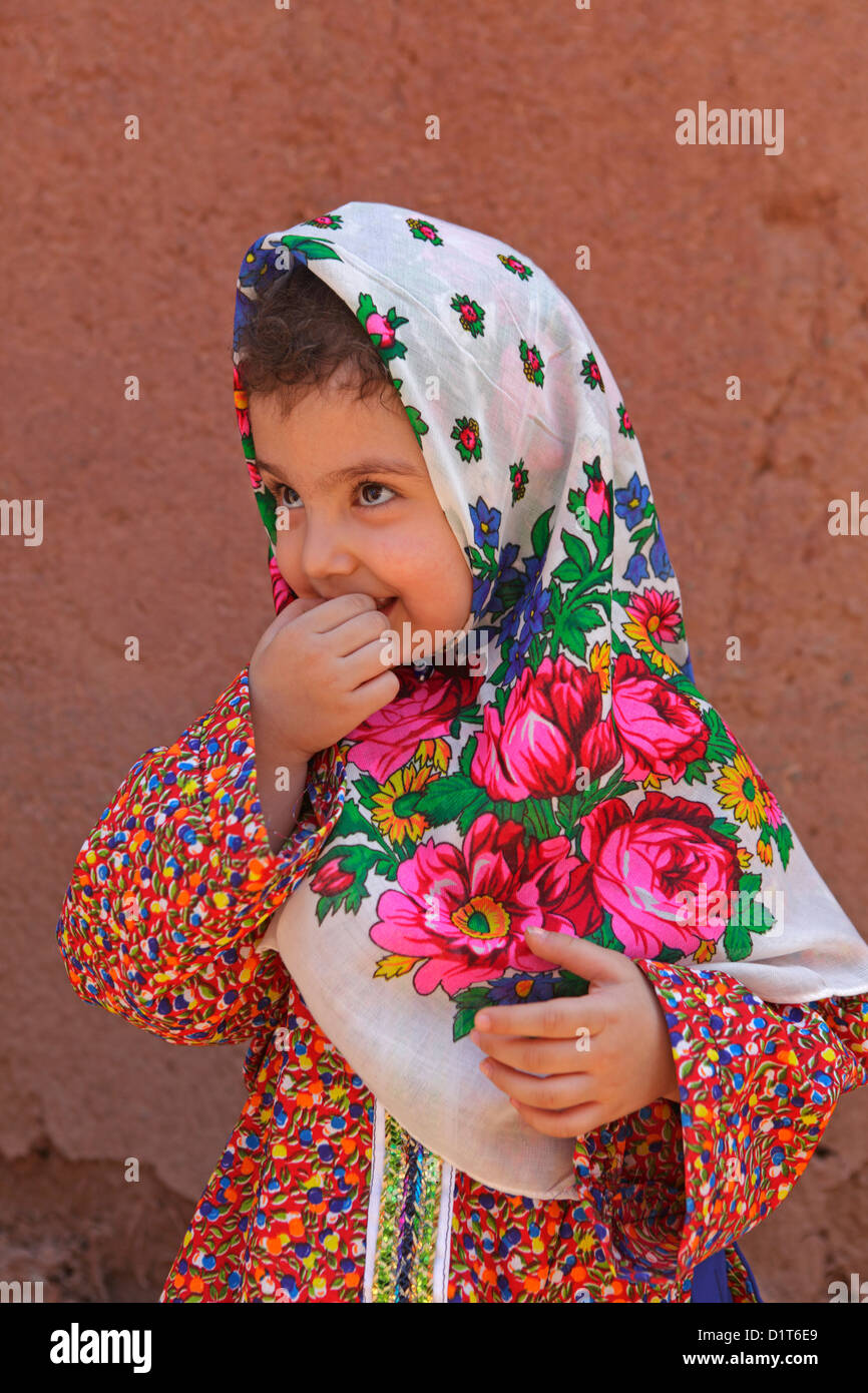 Portrait of iranian little girl wearing the traditional floreal chador, Abyaneh, Iran Stock Photo