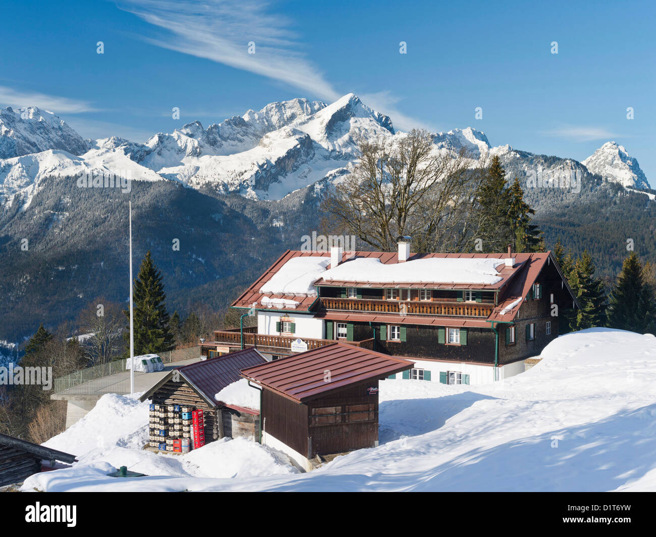 Wetterstein Mountain range in winter. Sunrise over the peak of Alpspitze, the mountain inn Eckbauer. Stock Photo