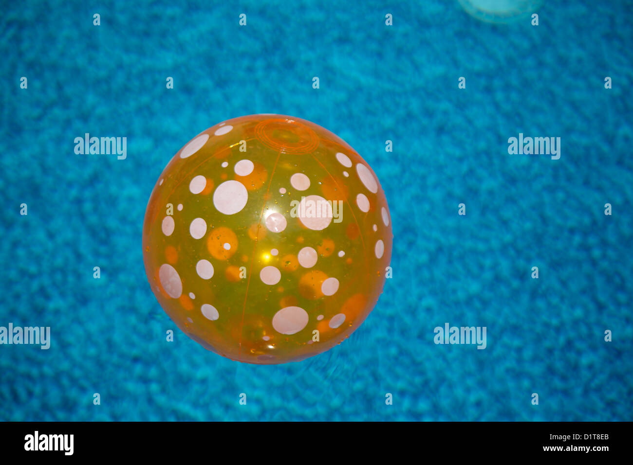 transparent 0range beach ball with white spots Stock Photo