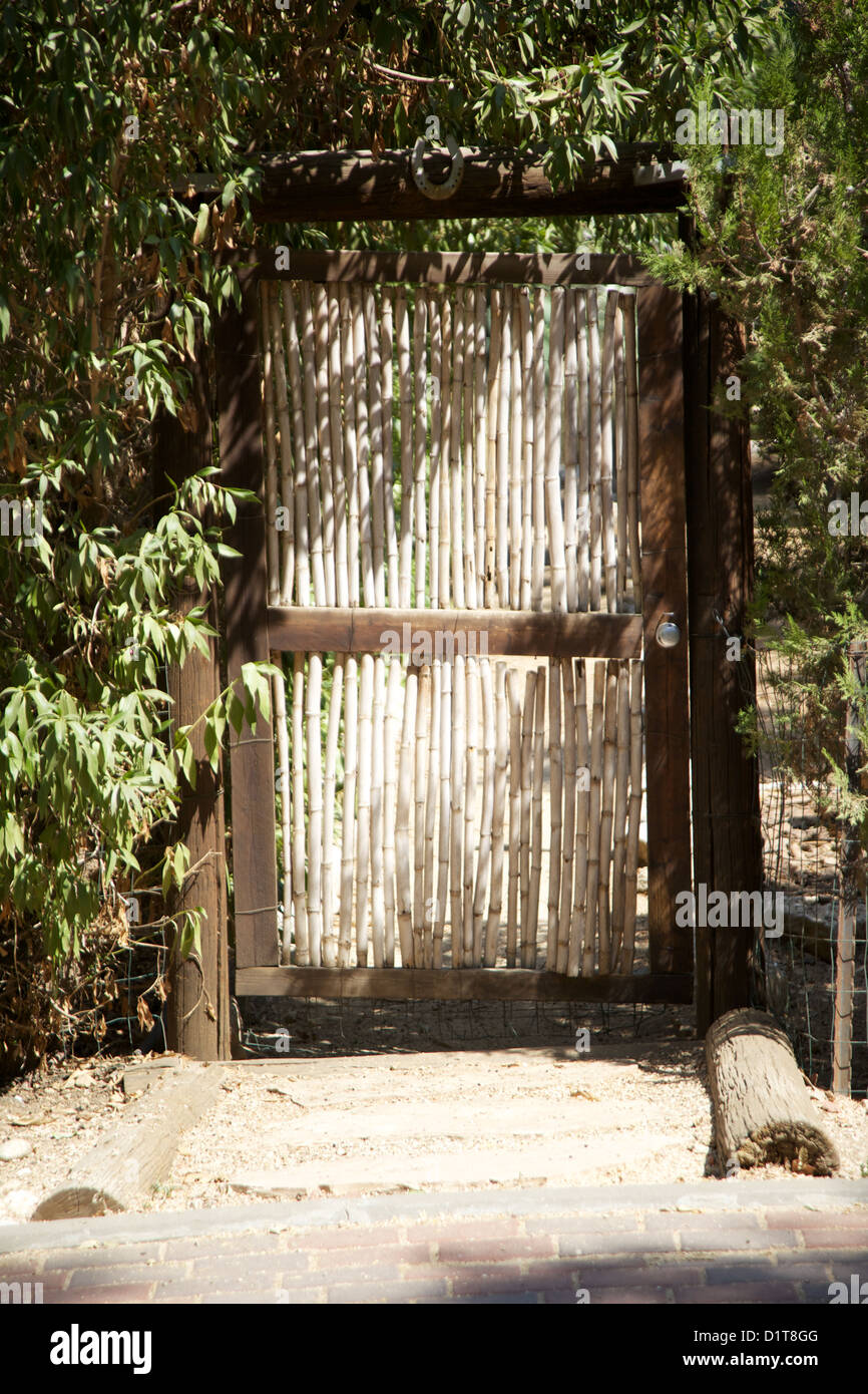 wood and grass door surrounded by foliage Stock Photo Alamy