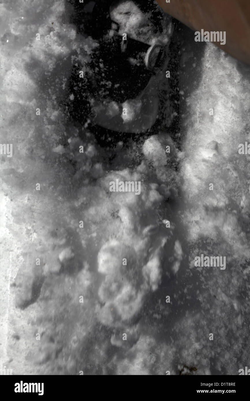 Snow flying ahead of a snowshoe in snow. Stock Photo