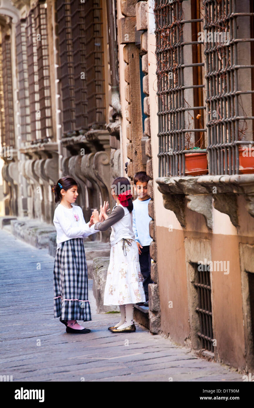 Europe, Italy, Lucca. Children Playing along the Streets of Lucca Stock Photo