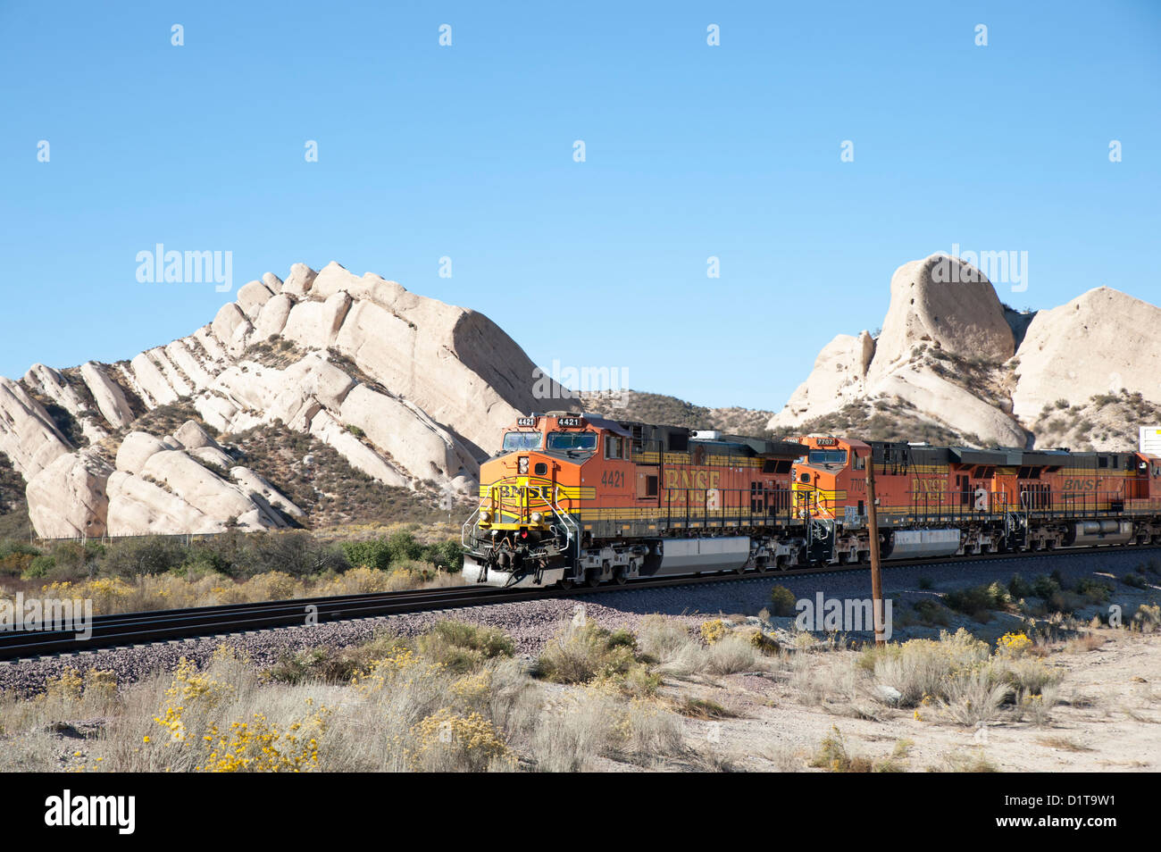 A BNSF locomotive passes near Mormon Rocks in Cajon Pass, San Bernardino County, California, USA Stock Photo