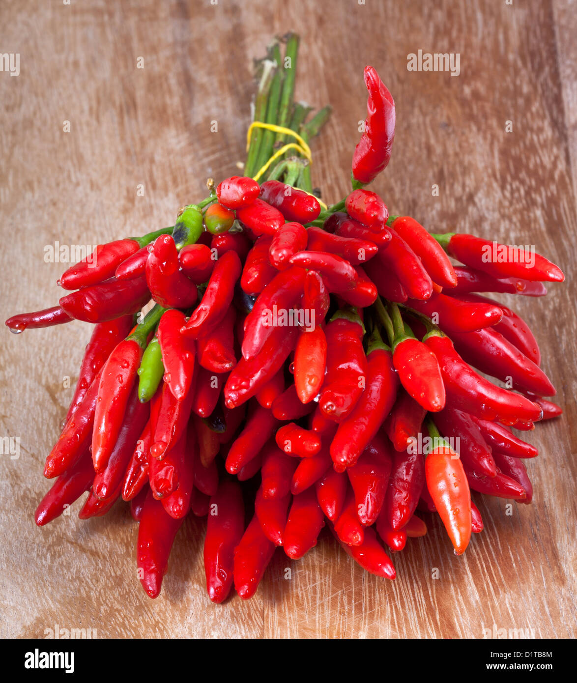 bunch of fresh small cayenne red pepper on wood table Stock Photo - Alamy