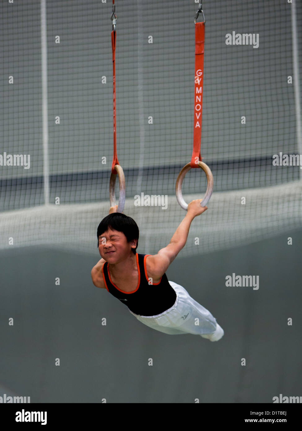 Young boy gymnastics with Roman rings Stock Photo - Alamy