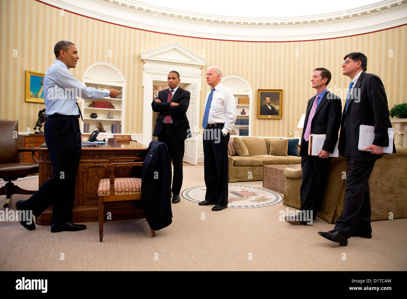 US President Barack Obama gives direction on the fiscal cliff negotiations to Rob Nabors, Assistant to the President for Legislative Affairs; the Vice President; Bruce Reed, Chief of Staff to the Vice President, and Chief of Staff Jack Lew in the Oval Office of the White House December 31, 2012 in Washington, DC. Stock Photo
