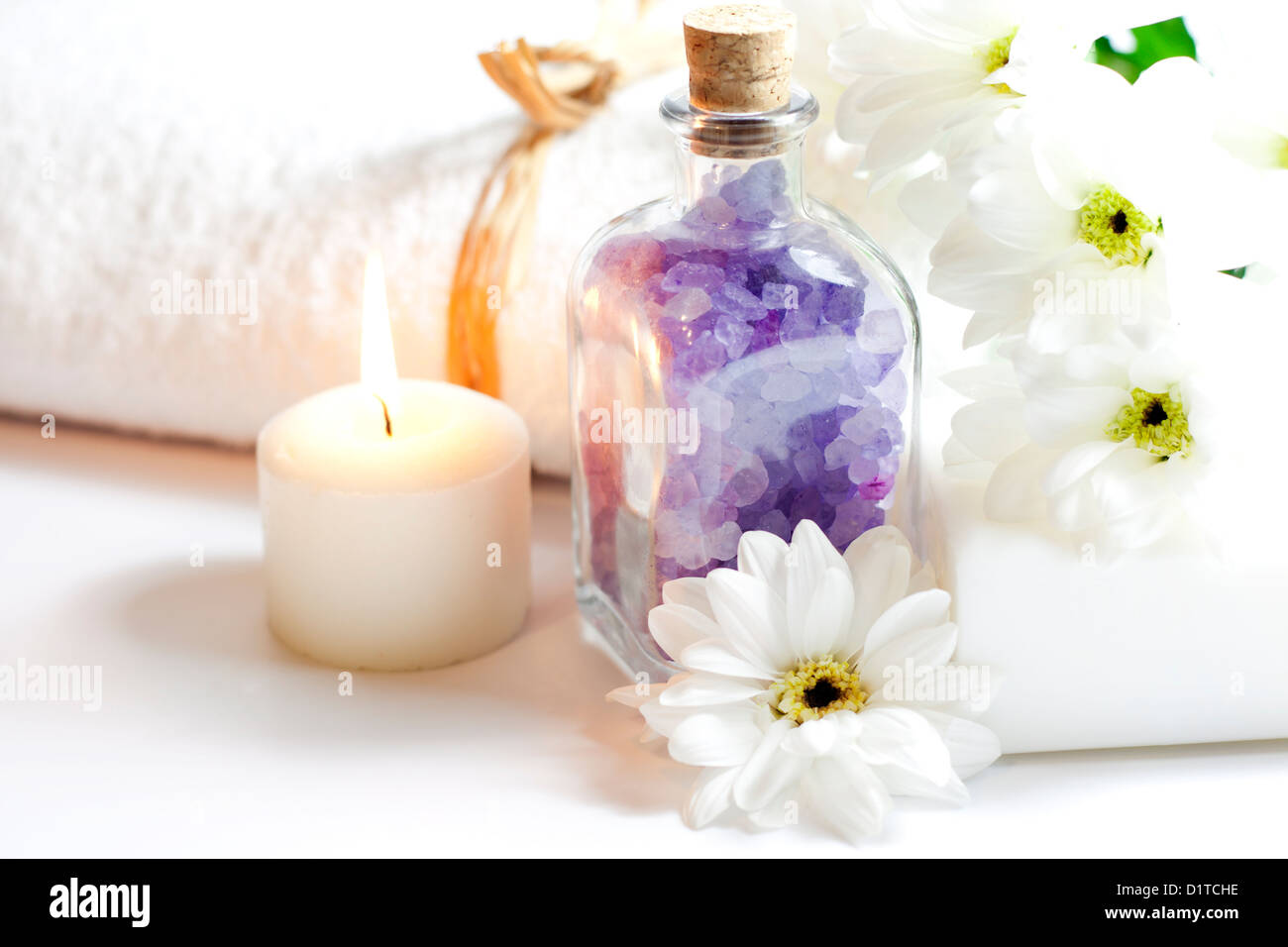 Bath salt and towel spa cosmetic concept on white background Stock Photo