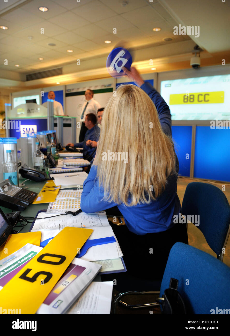 The DVLA Auction of Personalised Registrations at the Dormy House Hotel near Broadway, Worcestershire - an agent bids for a tele Stock Photo