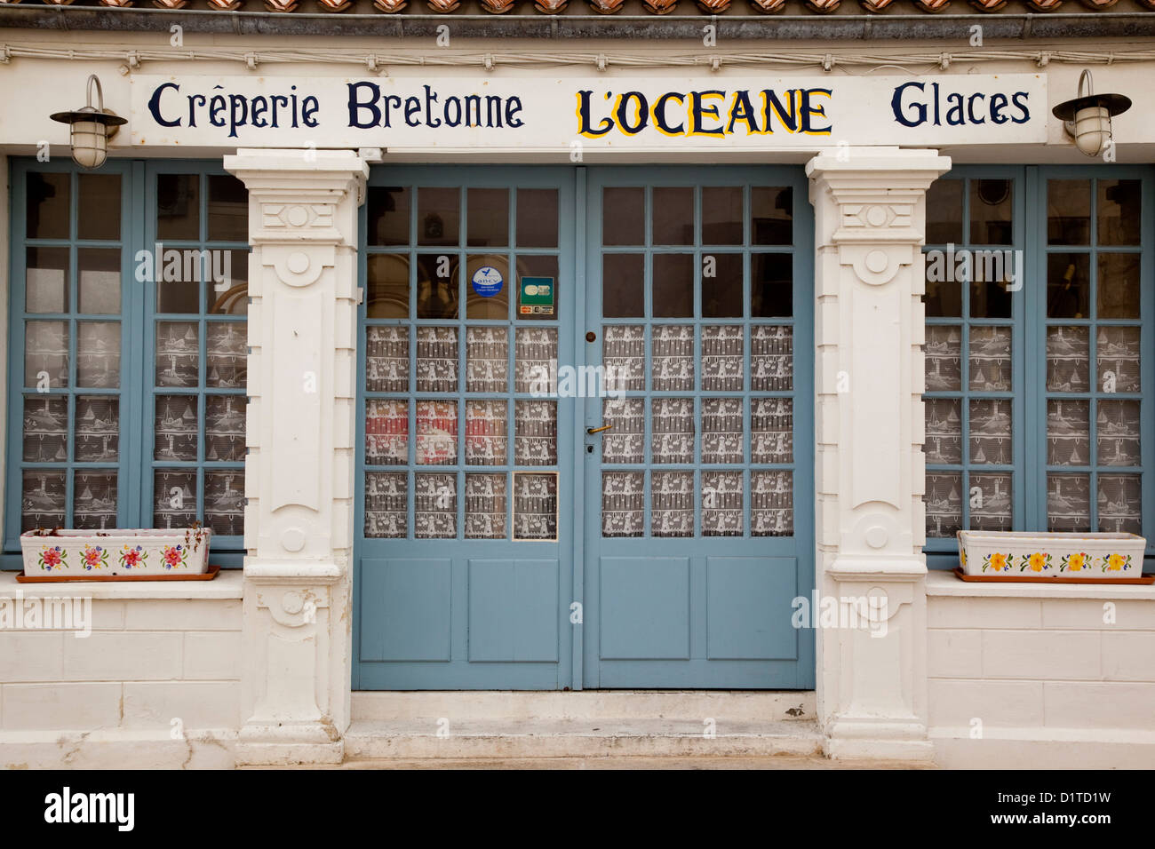 The store front of a Creperie on the French Atlantic island Il de Re,  its doors closed for the season. Stock Photo
