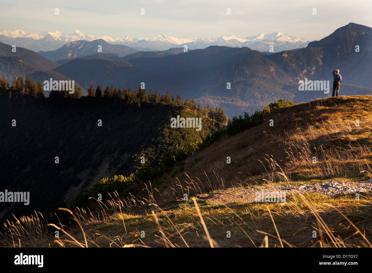 Landscape view of the German Alpine mountains. A elderly man looks ...