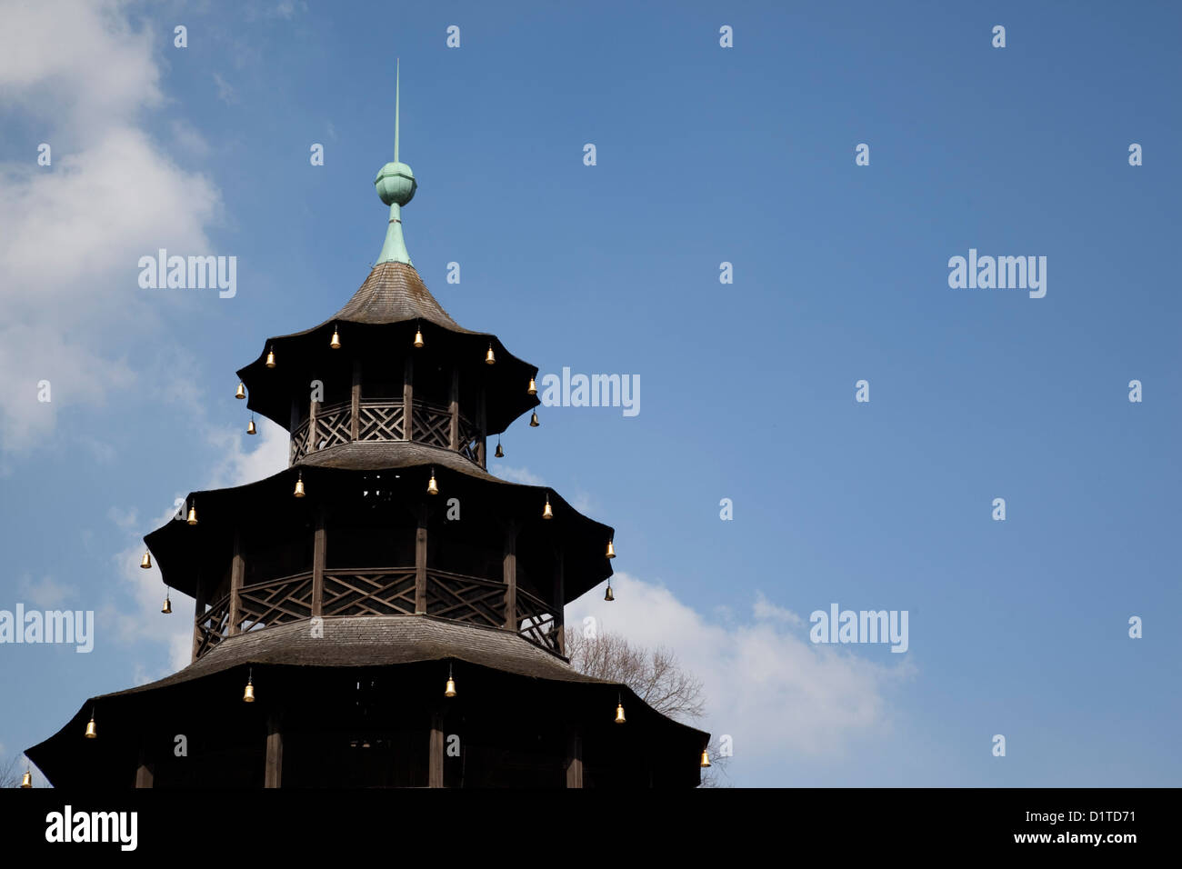 The Chinese Tower in the English Garden in Munich Germany is shown against a bright blue Bavarian sky. Stock Photo