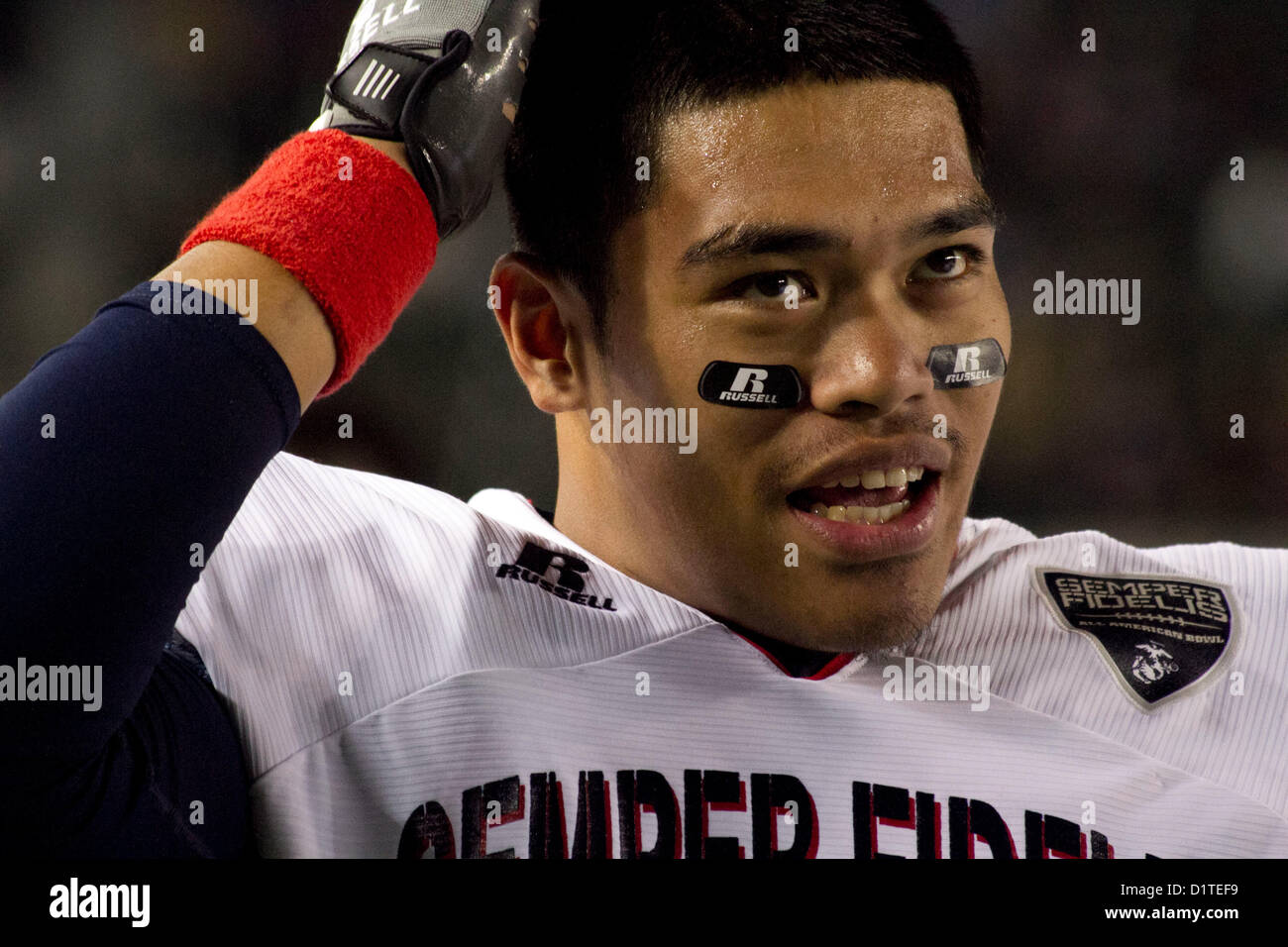 Paulo Lepua, a defensive tackle from Harbor City, Calif., and a member of the Semper Fidelis All-American Bowl Team West, watches the game, Jan. 4, 2013, at the Home Depot Center, Carson, Calif.  The Semper Fidelis All-American Bowl Is the culmination of the Marine Corps Semper Fidelis' Football Program, through which the Marine Corps purposefully engages with well-rounded student athletes to share leadership lessons that will enable future successes in their academic and athletic careers (U. S. Marine Corps Photo by Sgt. B. A. Curtis) Stock Photo