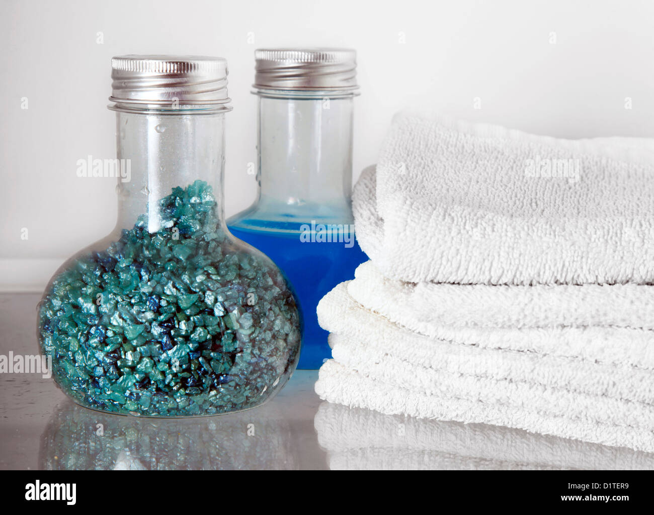 White towels and two bottles with shampoo and salt for baths Stock
