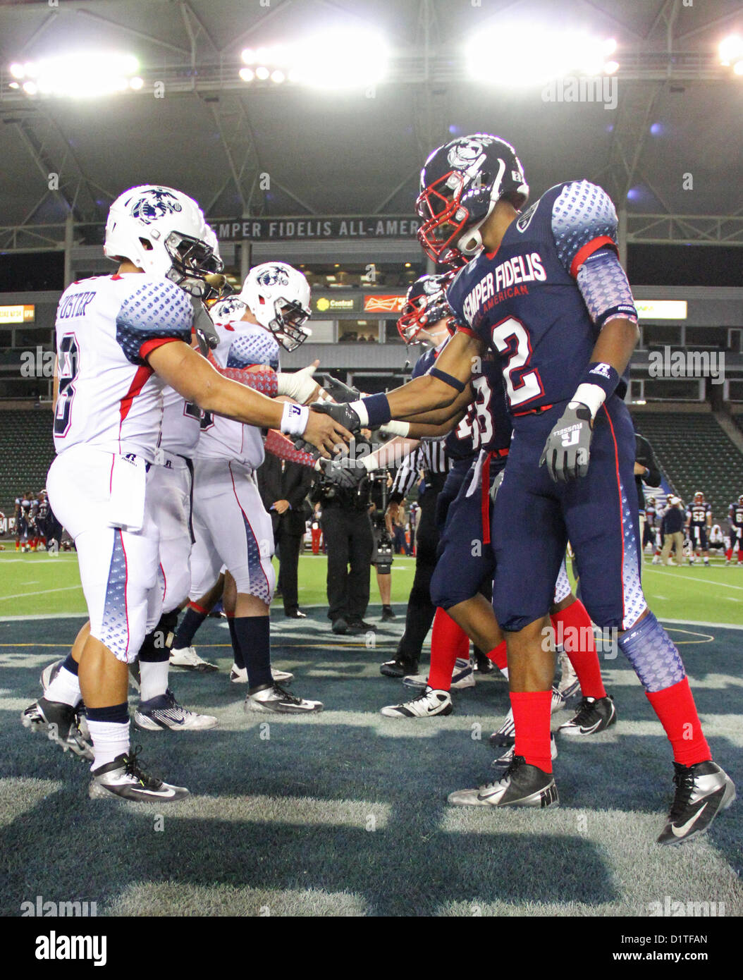 Players from the East and West teams shake hand before begining the Semper Fidelis All-American Bowl game, Jan. 4, 2013 at the Home Depot Center, Carson, Calif. The Semper Fidelis All-American Bowl is the culmination of the Marine Corps Semper Fidelis' Football Program, through which the Marine Corps purposefully engages with well-rounded student athletes to share leadership lessons that will enable future successes in their academic and athletic careers. (U.S. Marine Corps photo by Cpl. Jen S. Martinez) Stock Photo