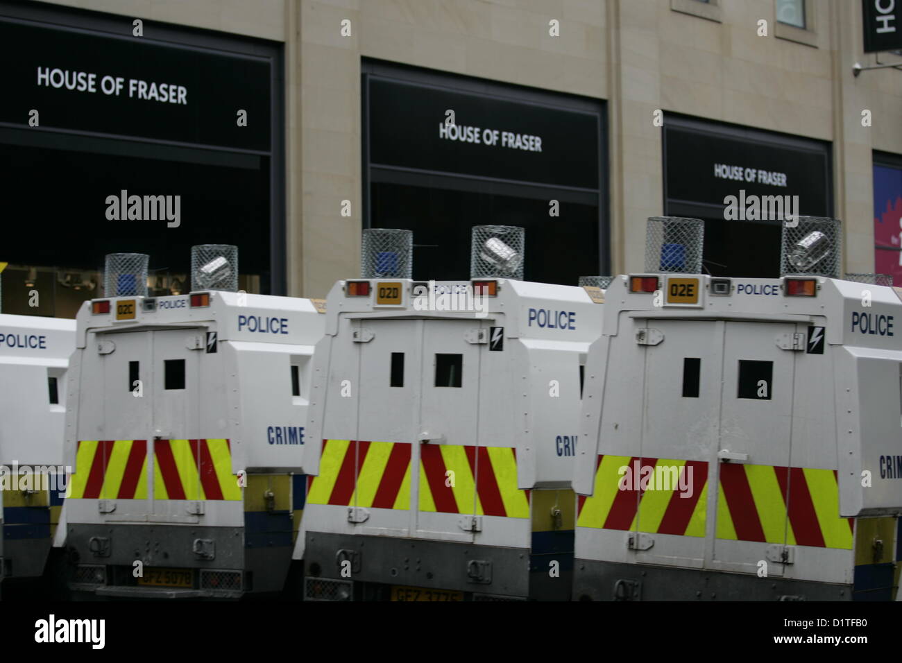 PSNI Landrovers pass the House of Fraser department store in Belfast , during the ongoing flag protest after Belfast City Council voted on the 3rd of December 2012 to restrict the flying the Union Jack flag from City hall to 17 days per year, where previously it flew every day of the year. Belfast, Northern Ireland. Bonzo/Alamy Live News Stock Photo