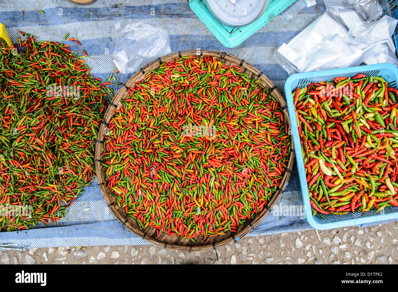 LUANG PRABANG, Laos - Small chili peppers known as Prik Ki Nu (Thailand) or Mak Pet Ki Nuu (Laos). The morning market in Luang Prabang, Laos. Starting early in the morning, local vendors converge on this street in downtown Luang Prabang to sell to locals. Their wares are primarily food, but there are also a few souvenir stalls for the tourists. Stock Photo