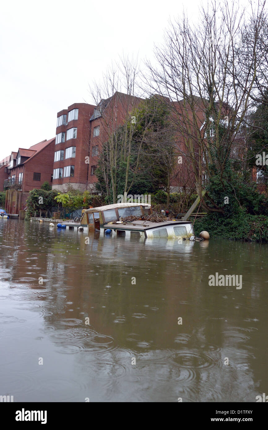 Traditional Broads cruiser sunk at her moorings in Thorpe on the outskirts of Norwich on the River Yare, Broads National Park Stock Photo