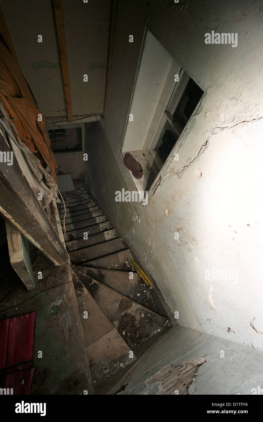 Derelict stairwell and window of an abandoned house on The Isle of
