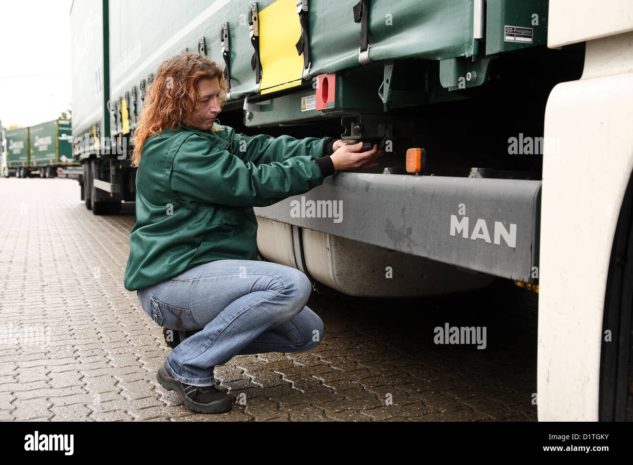 Braunschweig, Germany, trucker Inge meadow controls her truck before departure Stock Photo