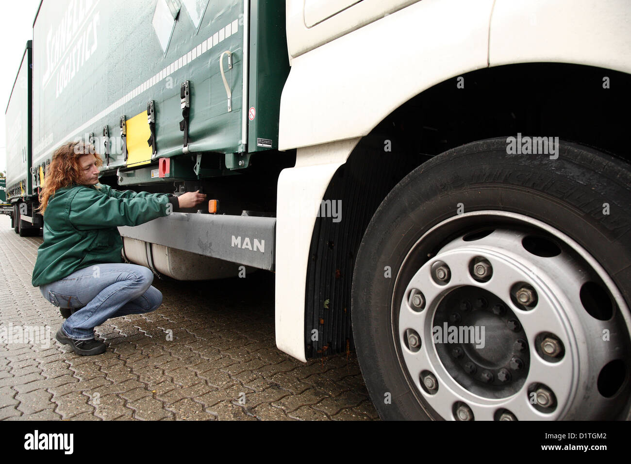 Braunschweig, Germany, trucker Inge meadow controls her truck before departure Stock Photo