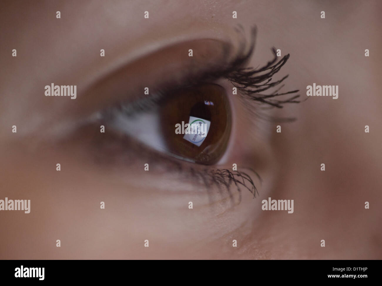 Berlin, Germany, mirroring the Bayer logo in the eye of a woman Stock Photo