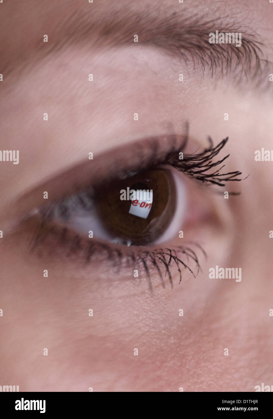 Berlin, Germany, mirroring the EON logo in the eye of a woman Stock Photo