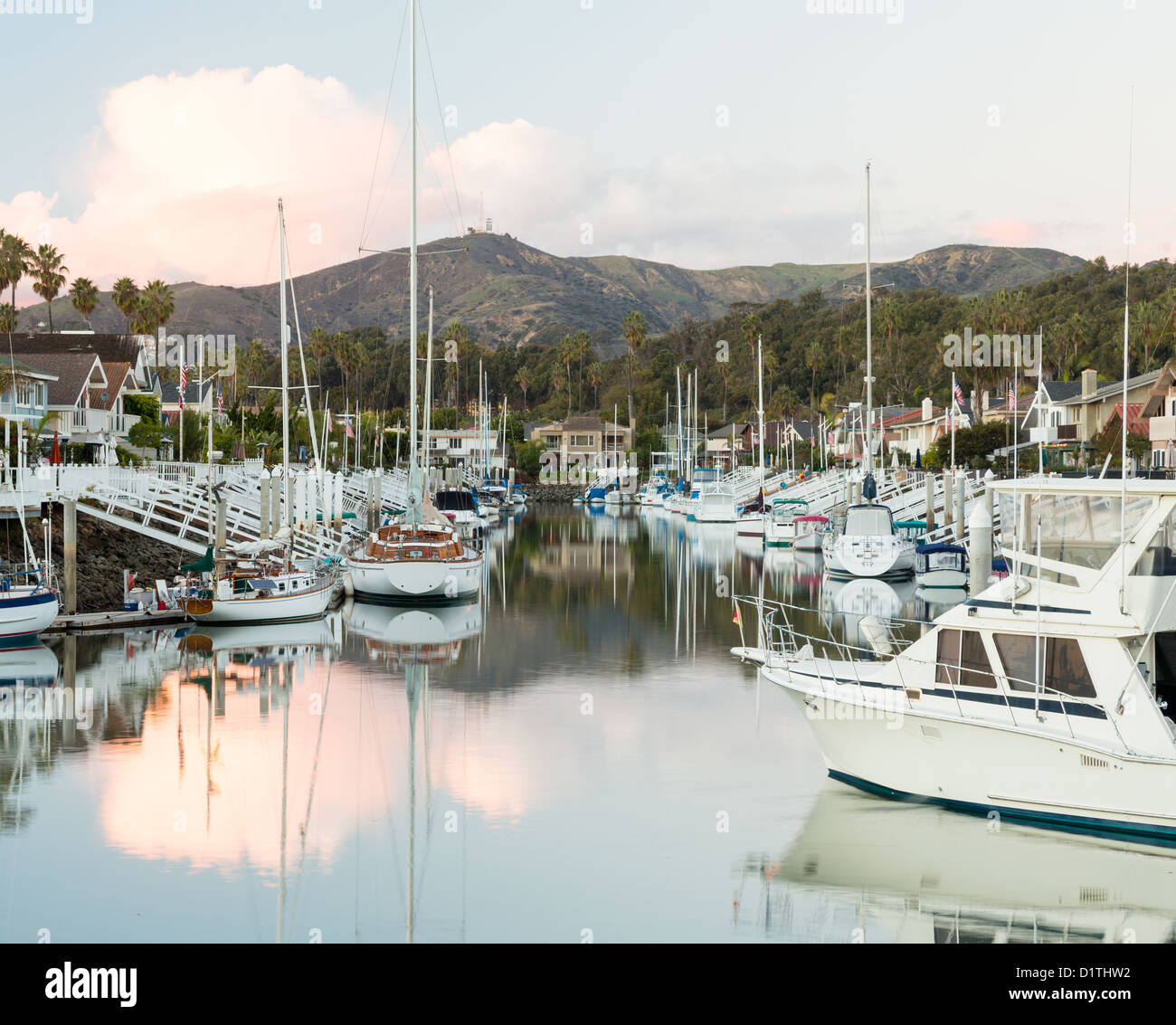 Sunset over luxury residential development with marina in Ventura California with modern homes and yachts boats Stock Photo