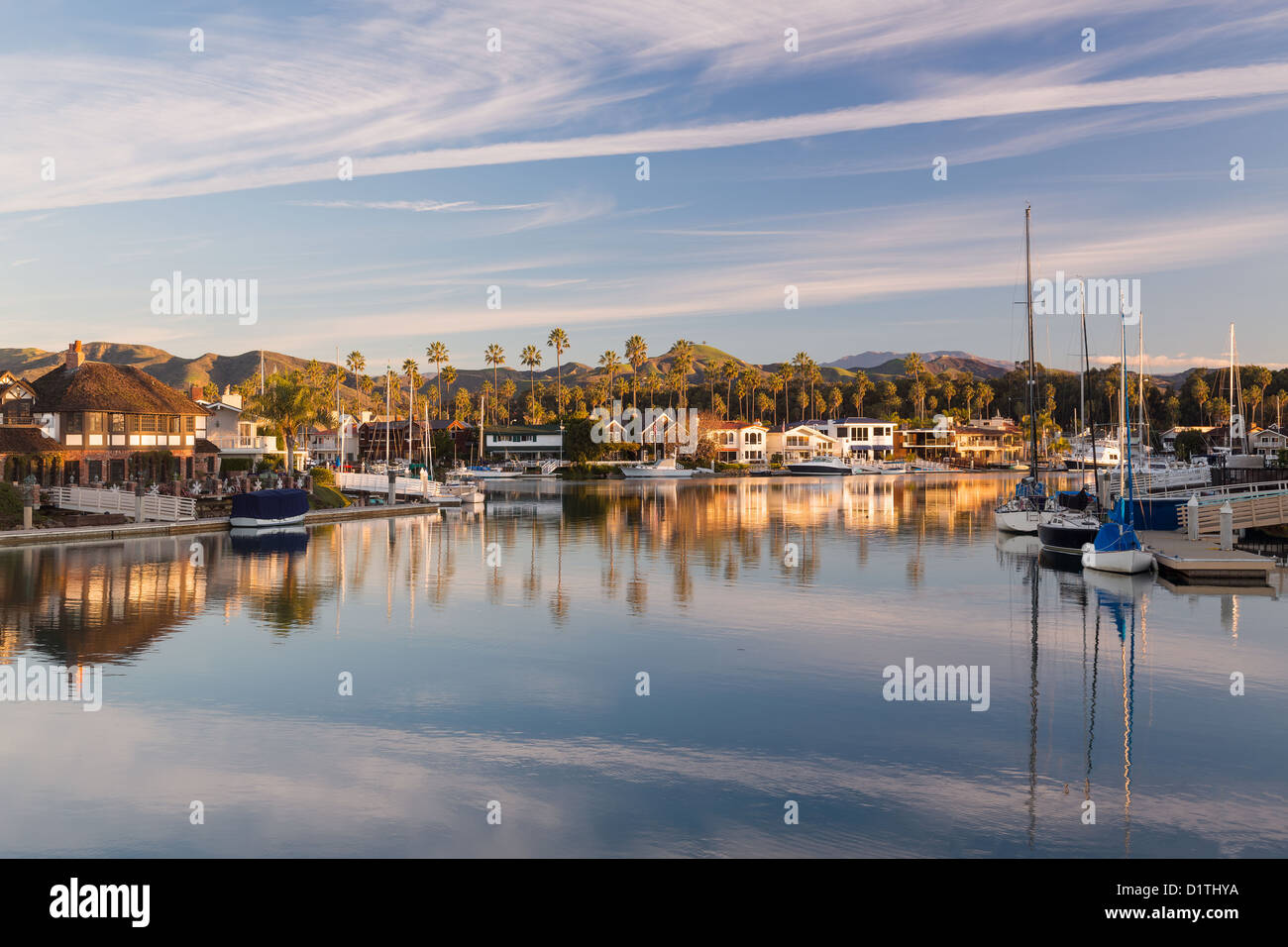 Sunrise at residential development by water in Ventura, California with modern homes and yachts boats Stock Photo