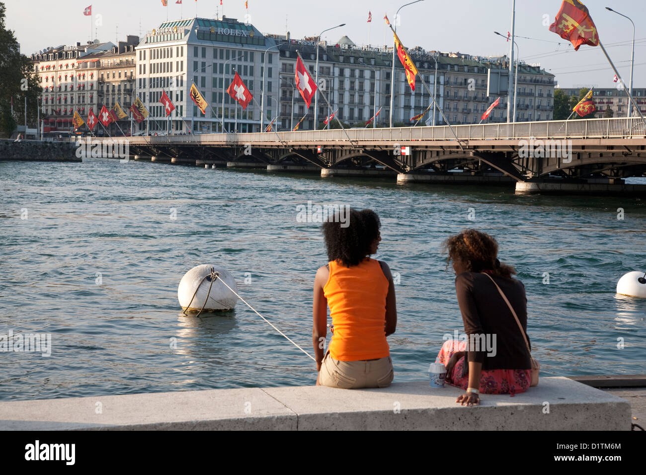 Two Young Women Relaxing by Lake Geneva; Geneva, Switzerland; Europe; Stock Photo