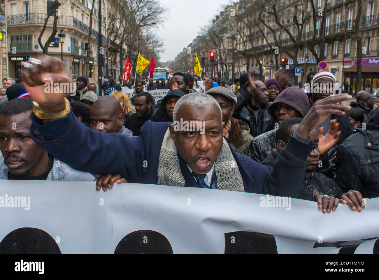 Paris, France, Sans Papers Protesting French Government, African Immigrants, Black Migrants, Holding up Fist, Chanting, Marching with Banners, activist protest, europe migrants, immigrant labor, immigrants rights, immigrant worker france, Europe Stock Photo