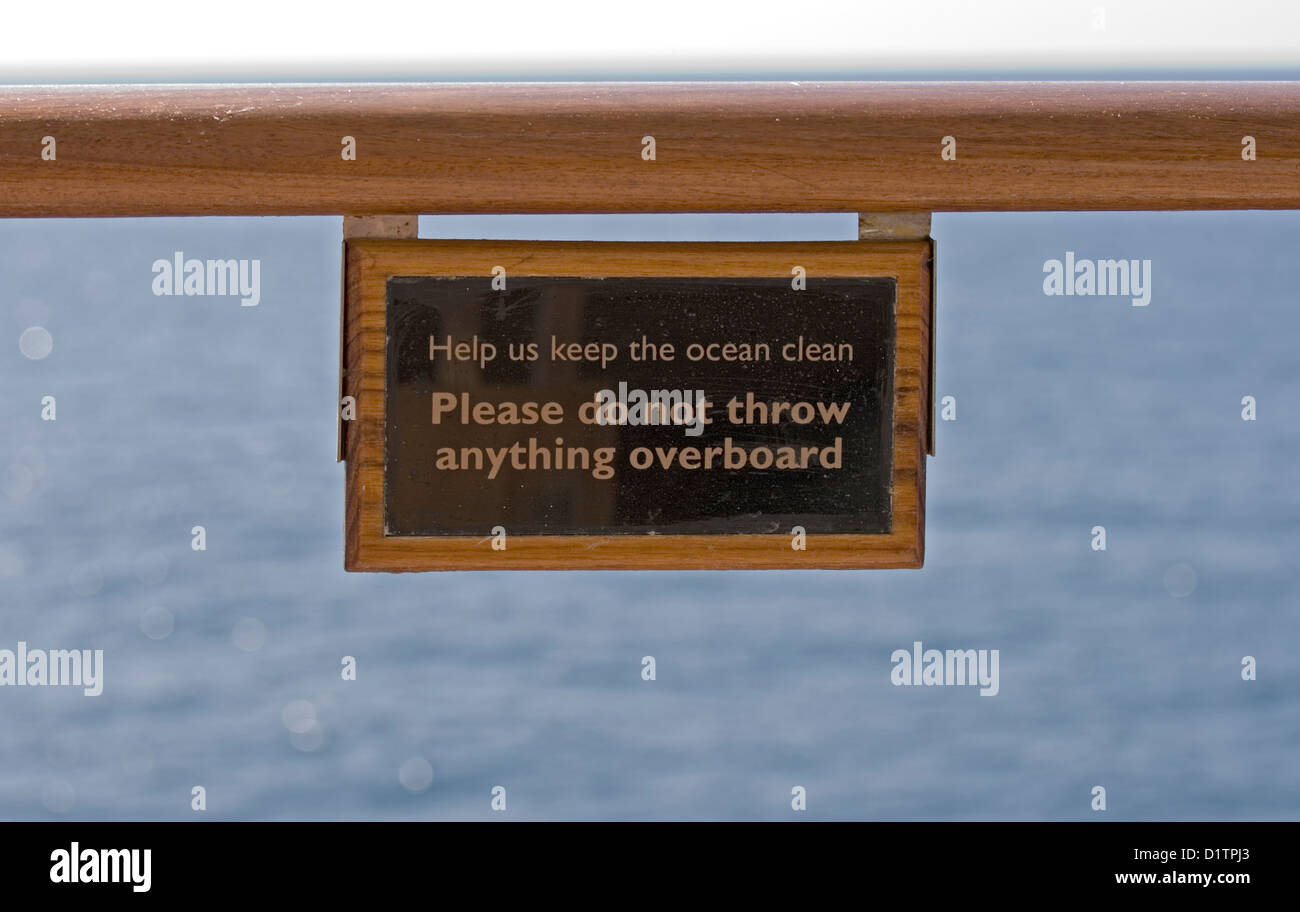 Notice on a rail on the Cunard cruise ship Queen Mary 2 advising not to pollute the sea by throwing anything overboard. Stock Photo