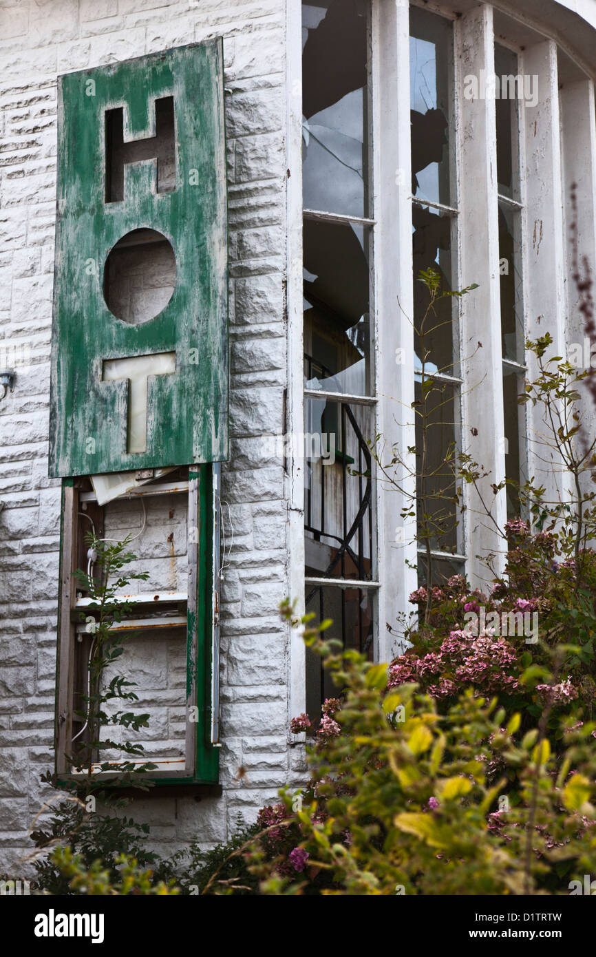 Abandoned hotel with damaged sign and broken windows Stock Photo - Alamy