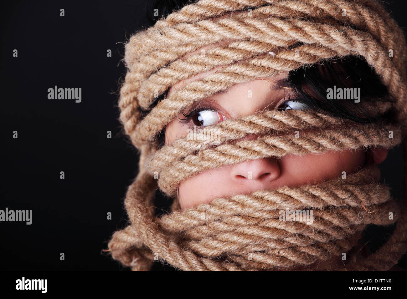 Tied up scared woman face. Violence concept.  Stock Photo