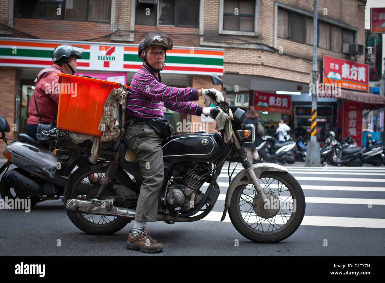 Motorcyclist stopped at intersection, Taipei Stock Photo