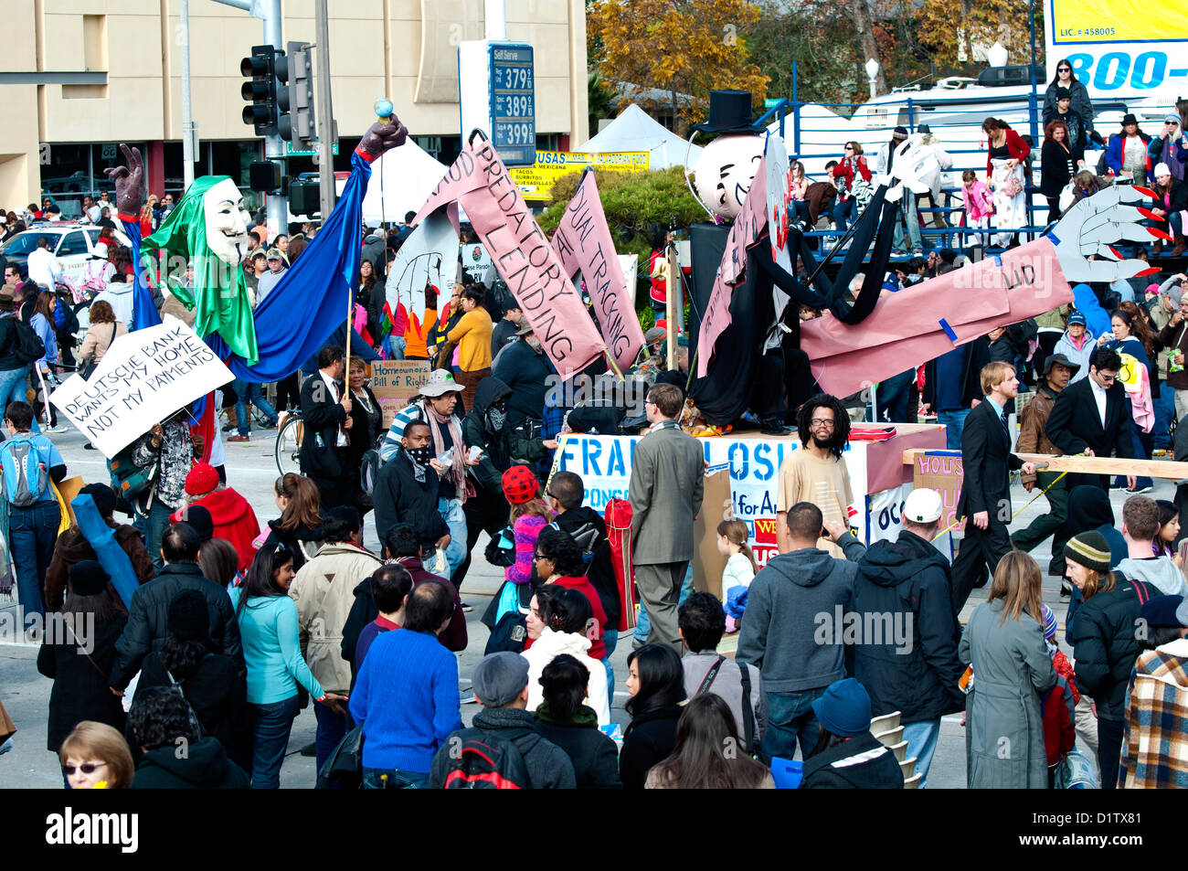 Protesters with the Occupy movement carry signs and characters to protest the foreclosure, 124th Rose Parade in Pasadena, 2013 Stock Photo