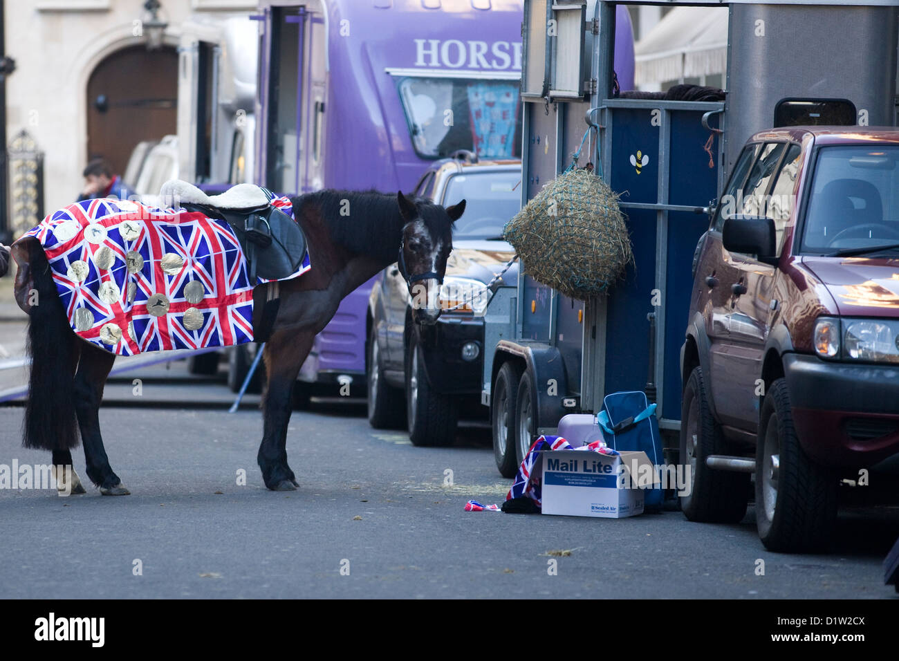 Horse stood by a horse box in Union Jack Rug in London UK Stock Photo
